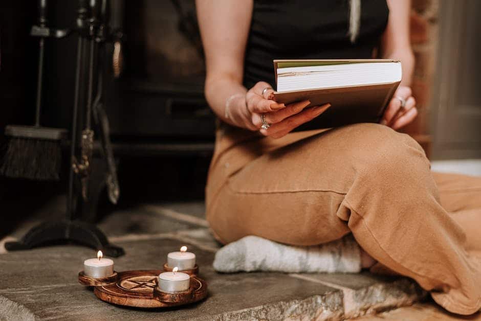 A witch in a modern setting, wearing symbolic jewelry and surrounded by plants, showcasing her connection with nature and spiritual beliefs.